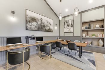 a conference room with desks and chairs and two televisions at Nobel Court, San Diego, California
